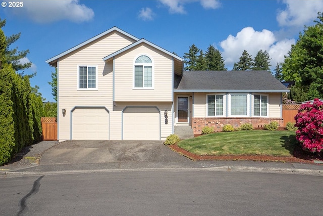 16485 SW Viking Ct, Beaverton, OR 97007 - split level home featuring an attached garage, driveway, and brick siding