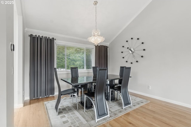 16485 SW Viking Ct, Beaverton, OR 97007 - dining space with a chandelier, ornamental molding, lofted ceiling, wood finished floors, and baseboards