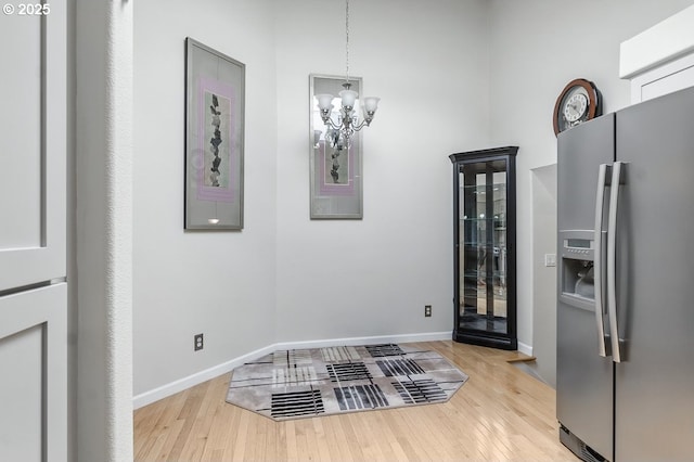 16485 SW Viking Ct, Beaverton, OR 97007 - interior space with light wood-style floors, a chandelier, and baseboards