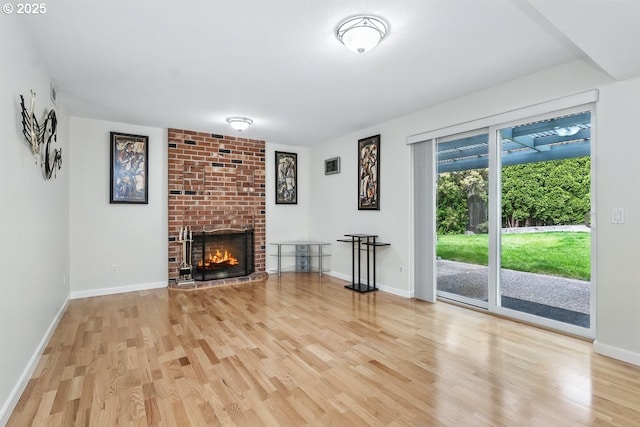 16485 SW Viking Ct, Beaverton, OR 97007 - unfurnished living room featuring wood finished floors, a fireplace, and baseboards