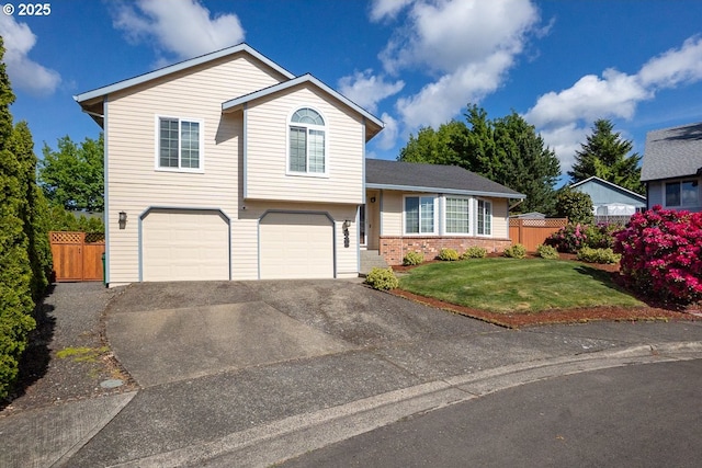16485 SW Viking Ct, Beaverton, OR 97007 - tri-level home with an attached garage, driveway, and brick siding