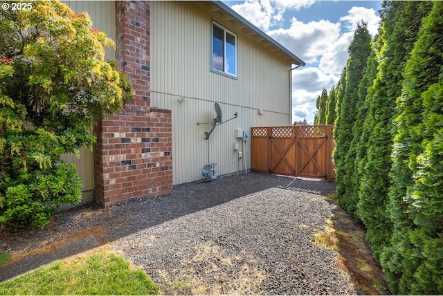 16485 SW Viking Ct, Beaverton, OR 97007 - view of property exterior with a gate and brick siding