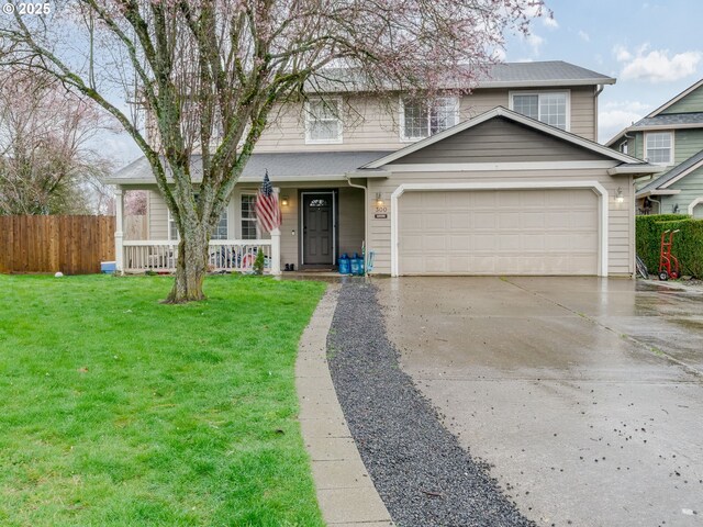 traditional home with driveway, covered porch, fence, a front lawn, and a garage
