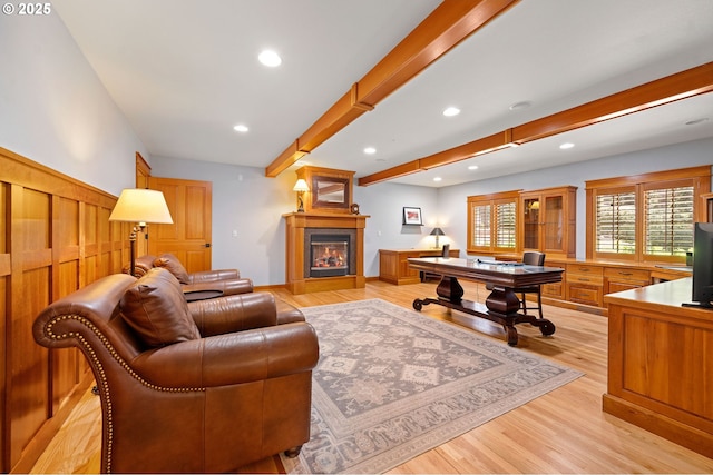 1635 SW 14th St, Warrenton, OR 97146 - living area with beamed ceiling, a glass covered fireplace, light wood finished floors, and recessed lighting