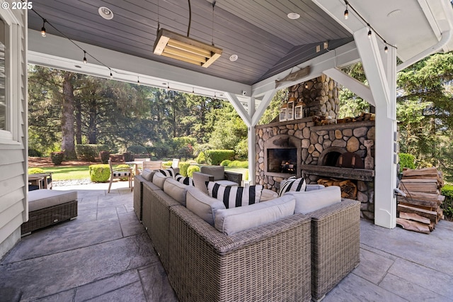 1635 SW 14th St, Warrenton, OR 97146 - view of patio with an outdoor living space with a fireplace and view of wooded area
