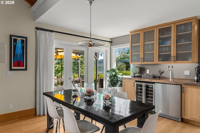 1524 Sherman Ave, Hood River, OR 97031 - dining room with light wood-style floors, wine cooler, french doors, bar area, and baseboards