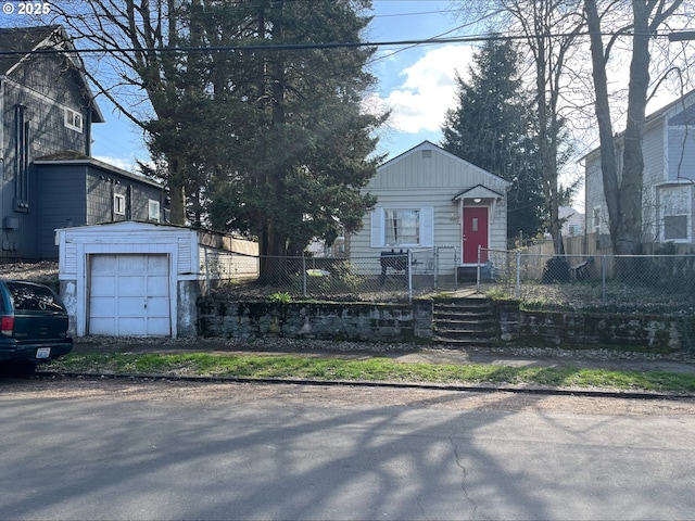 view of front of house with a fenced front yard and an outbuilding