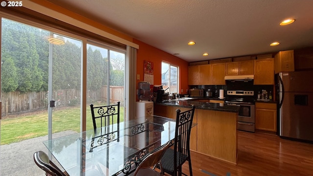 2113 SE 181st Ave, Vancouver, WA 98683 - kitchen featuring freestanding refrigerator, stainless steel range with electric cooktop, dark countertops, under cabinet range hood, and recessed lighting