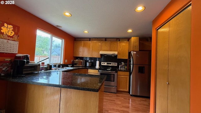 2113 SE 181st Ave, Vancouver, WA 98683 - kitchen with appliances with stainless steel finishes, under cabinet range hood, a peninsula, recessed lighting, and light wood-style floors