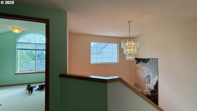 2113 SE 181st Ave, Vancouver, WA 98683 - hallway with carpet flooring, a chandelier, baseboards, and a textured ceiling