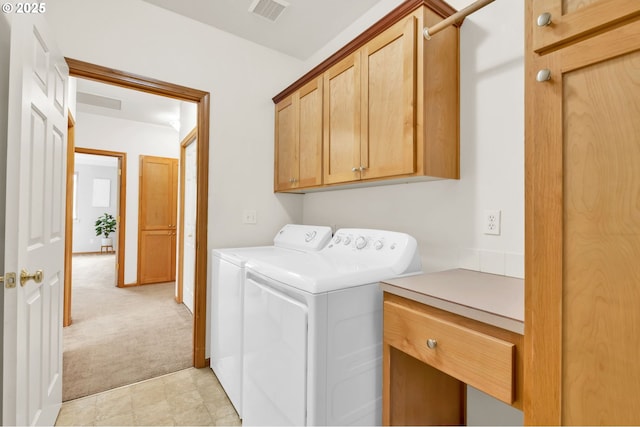 clothes washing area with cabinet space, independent washer and dryer, light colored carpet, and visible vents
