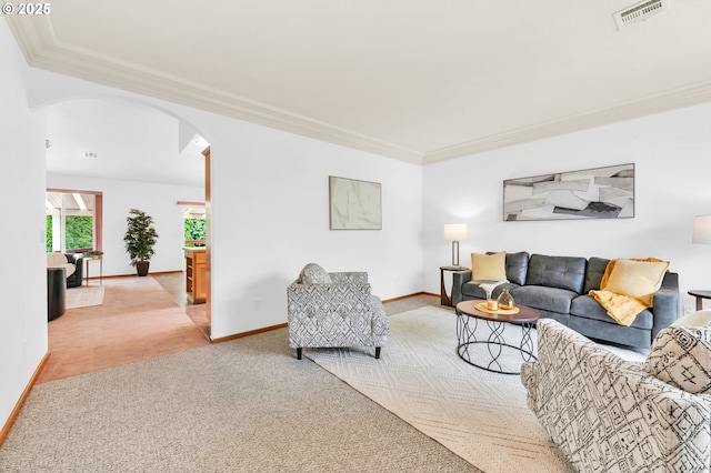 carpeted living area with crown molding, arched walkways, baseboards, and visible vents