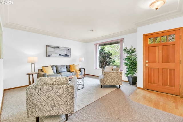 living area with crown molding and baseboards