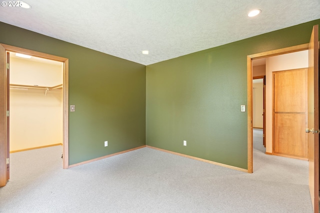 4740 SW Lowell Ct, Portland, OR 97221 - unfurnished bedroom featuring a walk in closet, carpet flooring, recessed lighting, and a closet