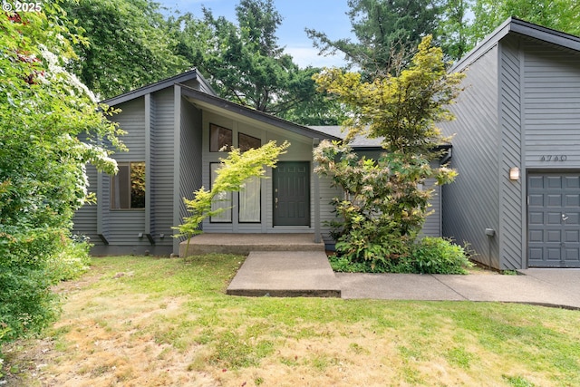 4740 SW Lowell Ct, Portland, OR 97221 - view of front of home featuring a front lawn and a garage