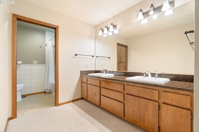 4740 SW Lowell Ct, Portland, OR 97221 - full bath with double vanity, a shower with shower curtain, and tile walls