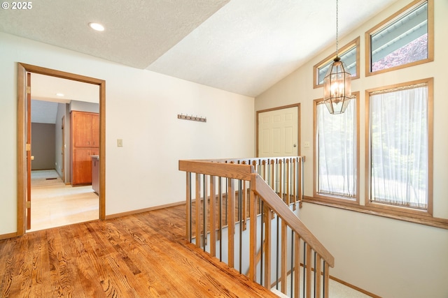 4740 SW Lowell Ct, Portland, OR 97221 - hall featuring an upstairs landing, light wood-style floors, a chandelier, recessed lighting, and lofted ceiling