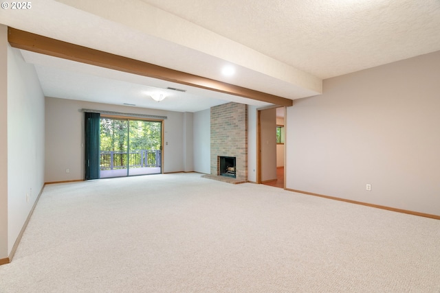 4740 SW Lowell Ct, Portland, OR 97221 - unfurnished living room with light colored carpet, a brick fireplace, and beam ceiling