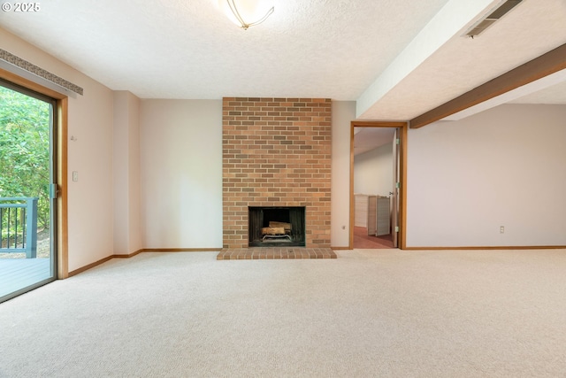 4740 SW Lowell Ct, Portland, OR 97221 - unfurnished living room featuring carpet floors, a brick fireplace, and a textured ceiling