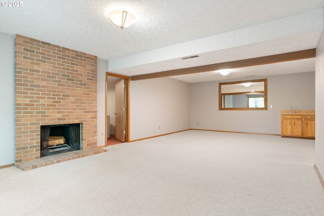 4740 SW Lowell Ct, Portland, OR 97221 - unfurnished living room featuring a textured ceiling, light carpet, and a fireplace
