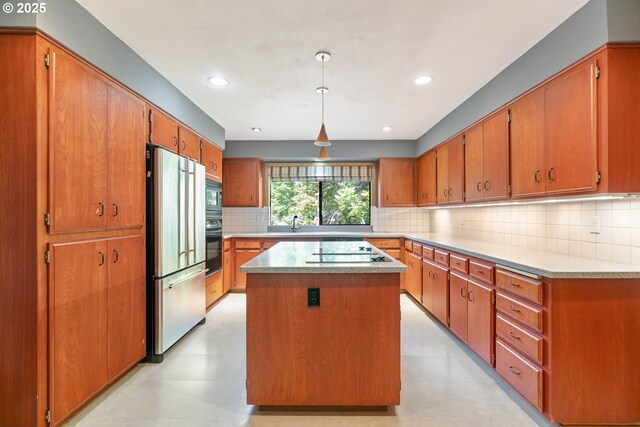 4740 SW Lowell Ct, Portland, OR 97221 - kitchen with black appliances, brown cabinets, backsplash, a center island, and light floors