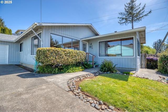 35565 Lower Loop Rd, Pacific City, OR 97135 - ranch-style home featuring a front yard, concrete driveway, and a garage