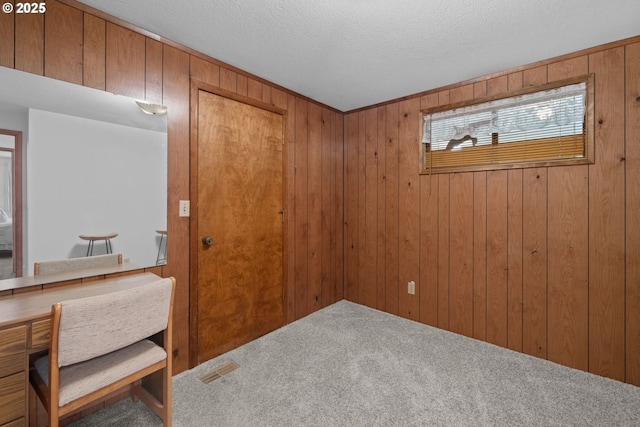 35565 Lower Loop Rd, Pacific City, OR 97135 - bedroom with carpet floors, wooden walls, and a textured ceiling