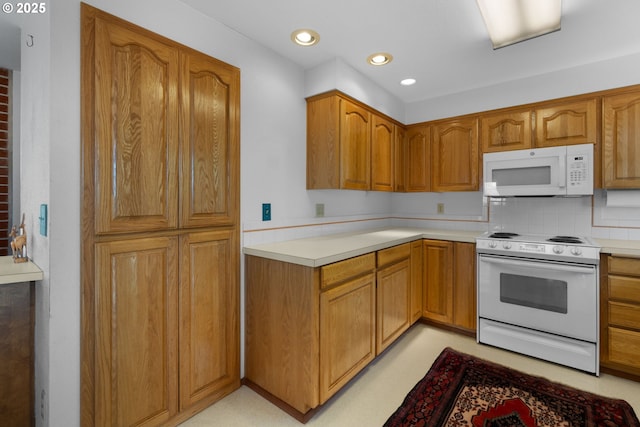 35565 Lower Loop Rd, Pacific City, OR 97135 - kitchen featuring white appliances, light countertops, brown cabinetry, and recessed lighting