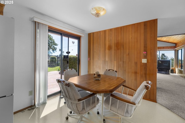 35565 Lower Loop Rd, Pacific City, OR 97135 - dining space with healthy amount of natural light, wood walls, baseboards, and lofted ceiling