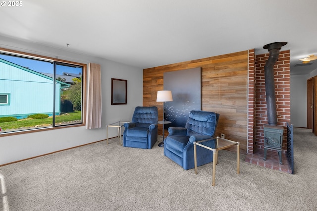 35565 Lower Loop Rd, Pacific City, OR 97135 - sitting room with wood walls, carpet, a wood stove, and baseboards