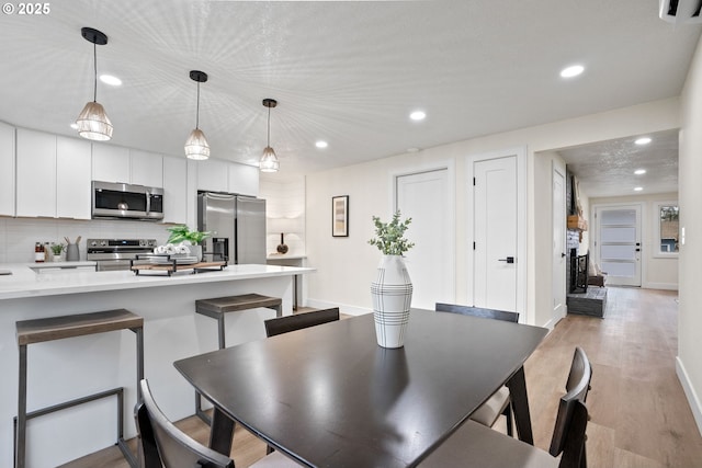 dining space featuring light hardwood / wood-style floors