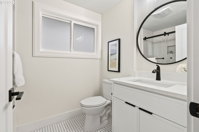 bathroom with a textured ceiling, toilet, an enclosed shower, and vanity