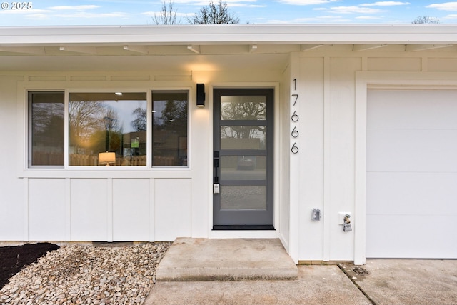 view of exterior entry featuring a garage