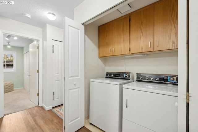 16146 SW 130th Ter Unit 2, Portland, OR 97224 - laundry room featuring cabinet space, washer and dryer, light wood-style floors, and baseboards
