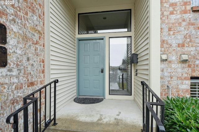 entrance to property featuring brick siding