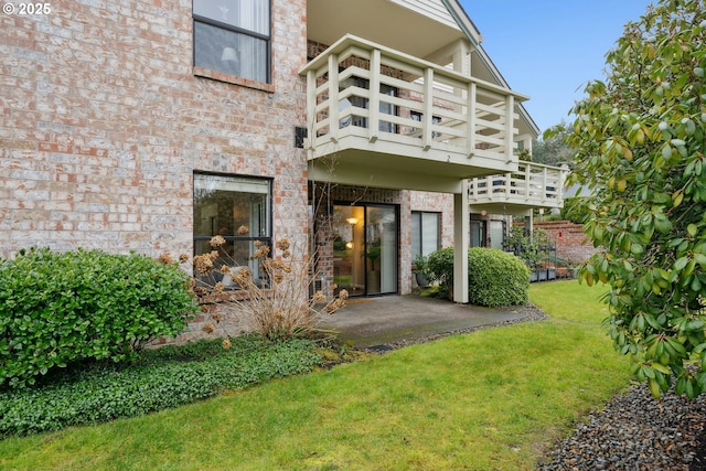 16146 SW 130th Ter Unit 2, Portland, OR 97224 - rear view of property with a balcony, a yard, brick siding, and a patio area