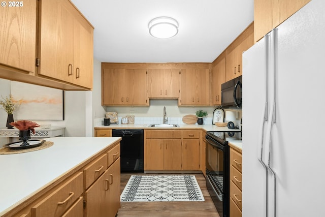 16146 SW 130th Ter Unit 2, Portland, OR 97224 - kitchen featuring black appliances, a sink, light countertops, and dark wood-style floors