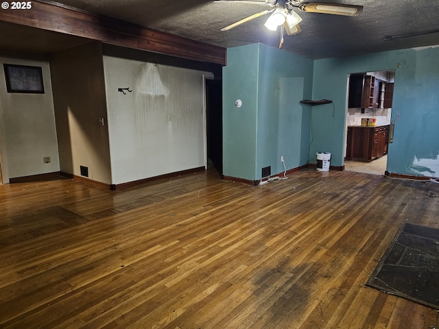 unfurnished living room featuring baseboards, a textured ceiling, a ceiling fan, and hardwood / wood-style flooring