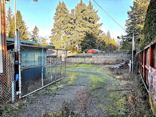 view of yard with an outdoor structure and fence