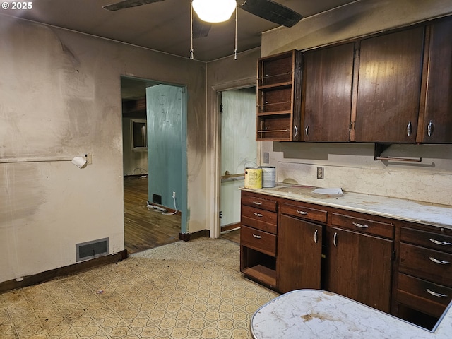 kitchen featuring visible vents, ceiling fan, baseboards, and open shelves