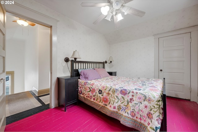 bedroom with ceiling fan, vaulted ceiling, wallpapered walls, and wood finished floors