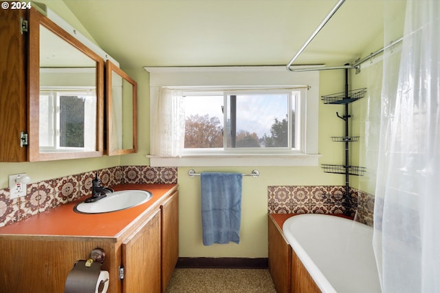 full bath featuring a shower with shower curtain, a bathtub, and vanity