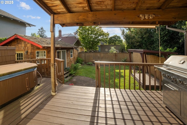wooden terrace with a lawn, a fenced backyard, and a grill