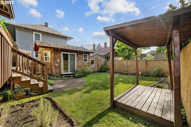 view of yard with fence private yard, a wooden deck, stairs, and entry steps
