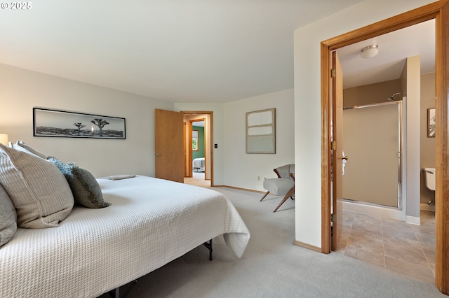 bedroom featuring light colored carpet and baseboards