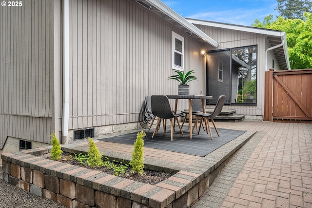 view of patio with outdoor dining area and a deck