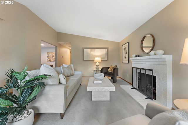 carpeted living area with baseboards, vaulted ceiling, and a fireplace