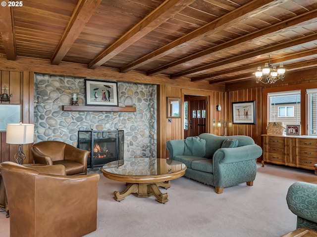 1021 S Prom, Seaside, OR 97138 - carpeted living area featuring a stone fireplace, a chandelier, wood walls, and wooden ceiling with exposed beams
