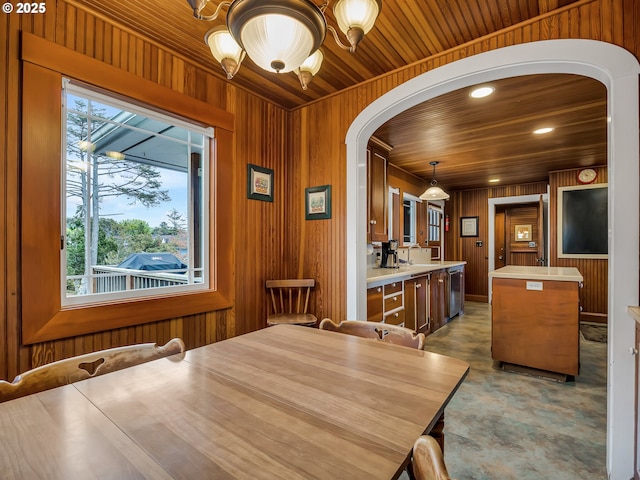 1021 S Prom, Seaside, OR 97138 - dining space with arched walkways, wood ceiling, wooden walls, healthy amount of natural light, and a chandelier