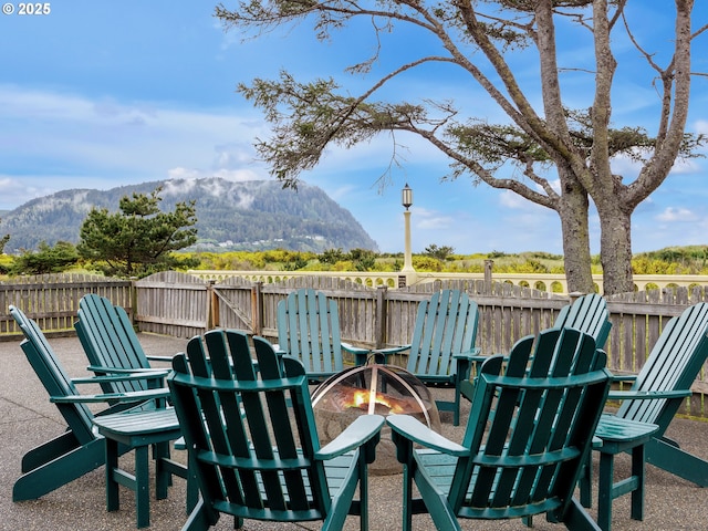1021 S Prom, Seaside, OR 97138 - view of patio featuring an outdoor fire pit and a mountain view